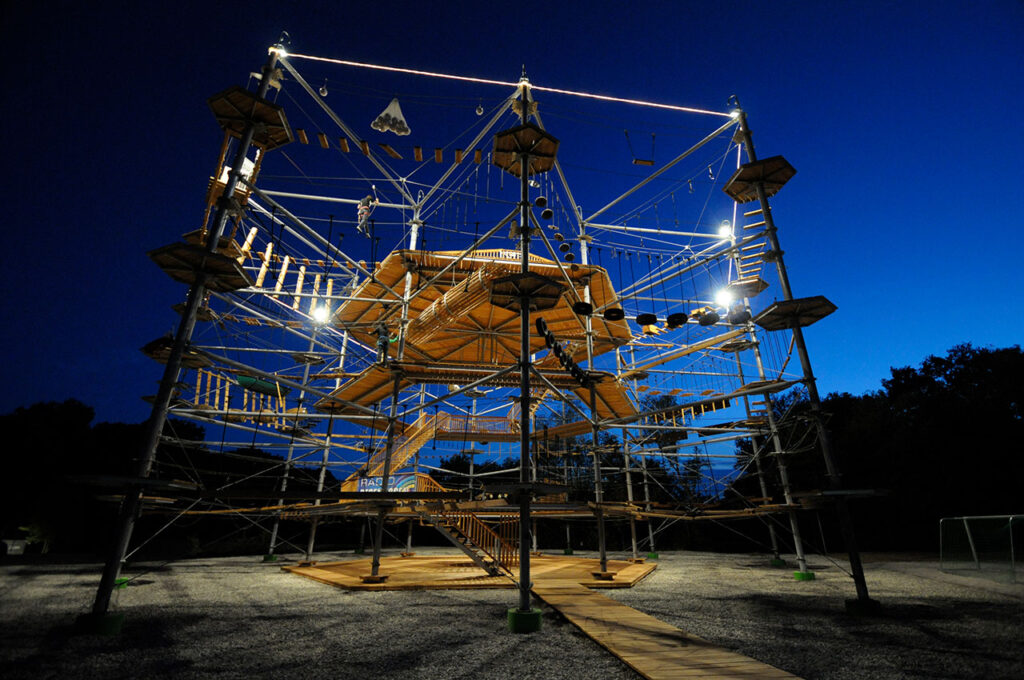 Climbing at night in a KristallTurm High Ropes Course